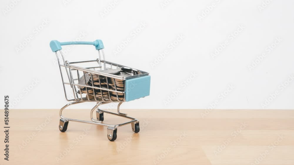 Stop motion animation Money stack on shopping cart, Money saving and economy concept. Stop motion animation Money stack on shopping cart, Money saving and economy concept.