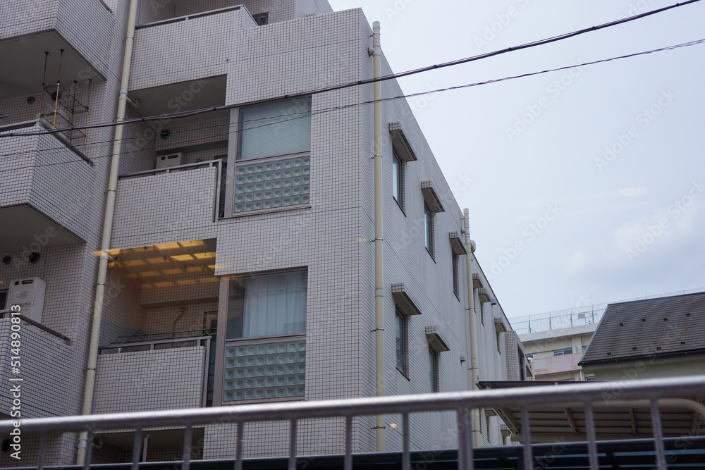 View of typical apartment residential and hotel building at Hatagaya district in Tokyo, Japan with clouds in blue sky background. No people. View of typical apartment residential and hotel building at Hatagaya district in Tokyo, Japan with clouds in blue sky background. No people.
