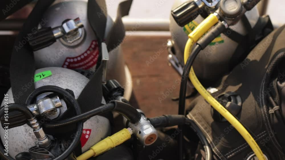 Male in wet suit with scuba gear and oxygen cylinder on the back. Preparing for diving. Male in wet suit with scuba gear and oxygen cylinder on the back. Preparing for diving.