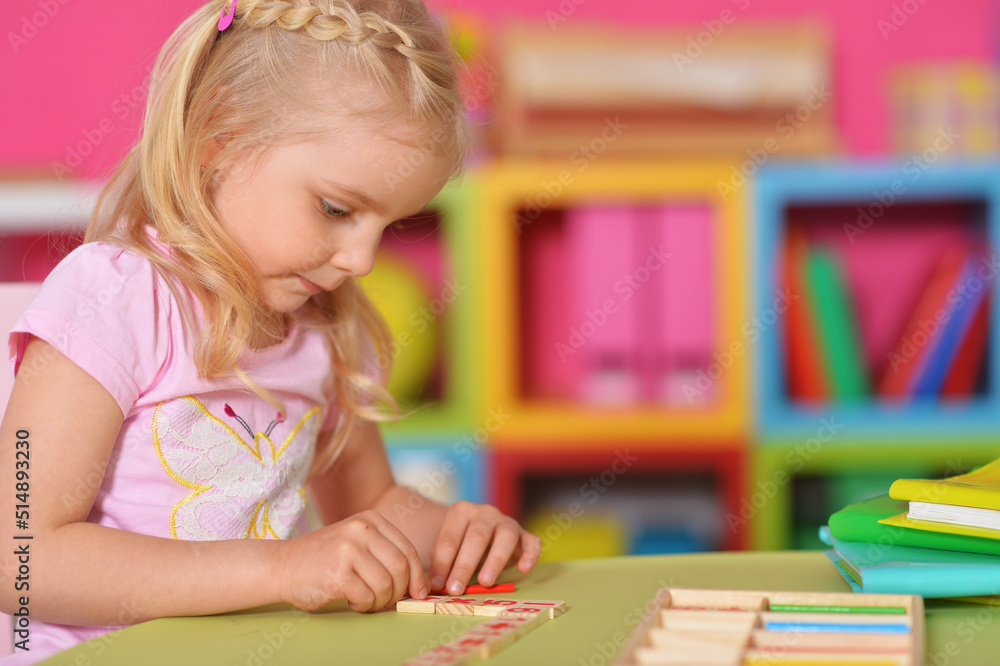 Little cute girl studying at the table at home Little cute girl studying at the table at home