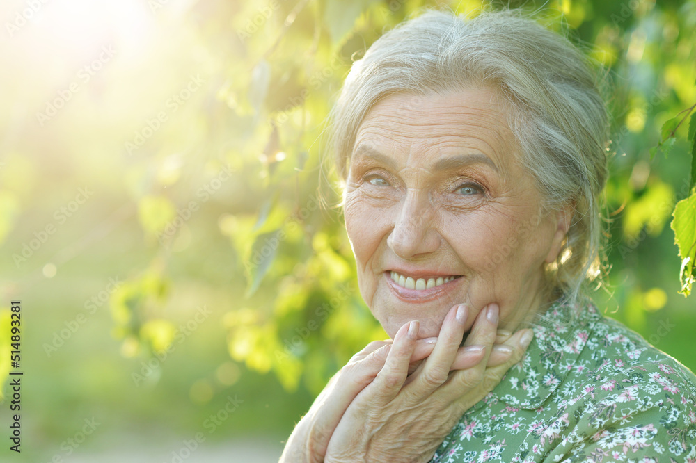 Happy smiling senior woman posing outdoors Happy smiling senior woman posing outdoors