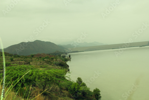 scenic view with lake near green forest photo