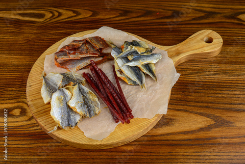 salted fish of various types as an appetizer for beer on a wooden board