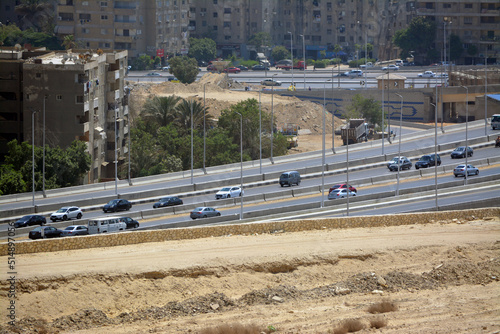 Aerial view of Cairo, Egypt from The Mokattam mountain and hills showing multiple buildings, streets, traffic, residential houses and bridges, selective focus photo