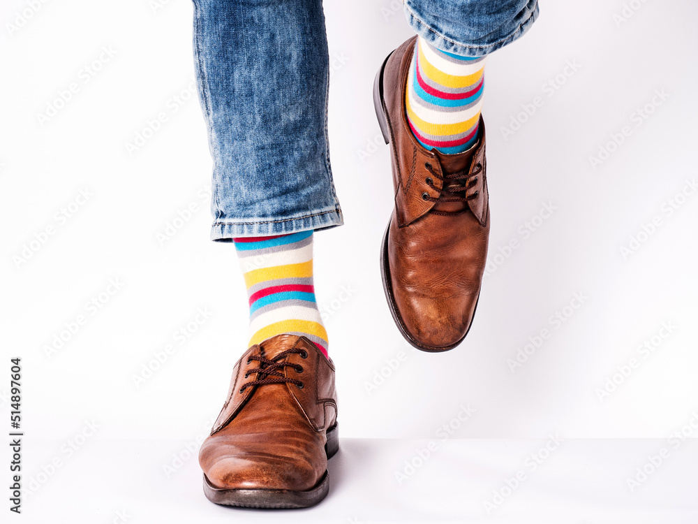 Men's legs, trendy shoes and bright socks. Closeup. Style, beauty and elegance concept Men's legs, trendy shoes and bright socks. Closeup. Style, beauty and elegance concept