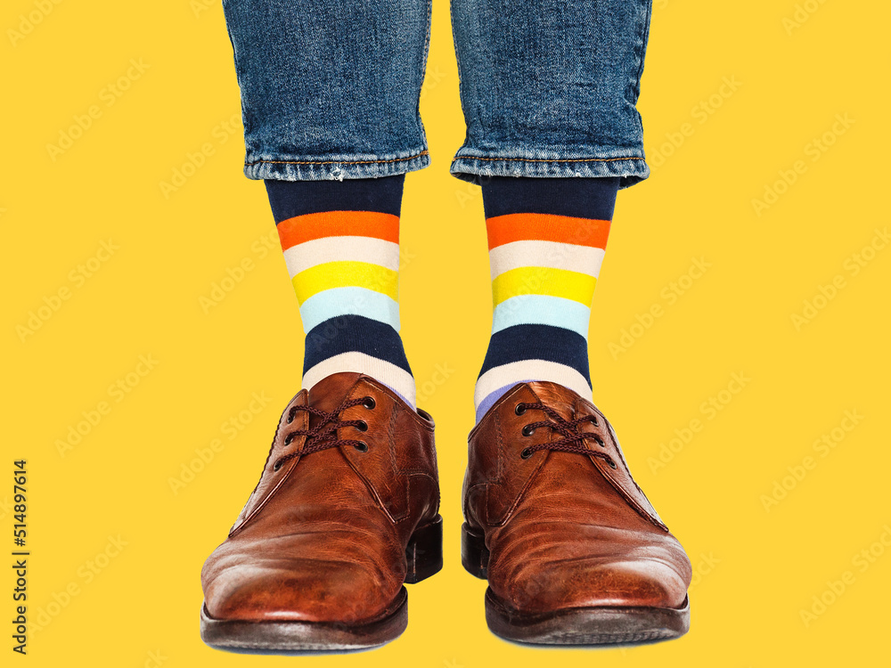 Men's legs, trendy shoes and bright socks. Closeup. Style, beauty and elegance concept Men's legs, trendy shoes and bright socks. Closeup. Style, beauty and elegance concept