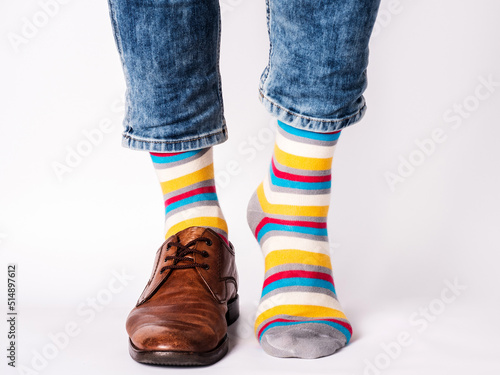 Men's legs, trendy shoes and bright socks. Closeup. Style, beauty and elegance concept