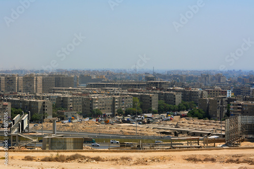 Aerial view of Cairo, Egypt from The Mokattam mountain and hills showing multiple buildings, streets, traffic, residential houses and bridges, selective focus photo