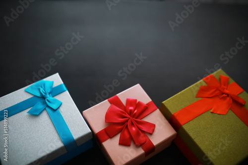 Christmas decoration. Gift boxes on black stone background. Christmas greeting card concept.