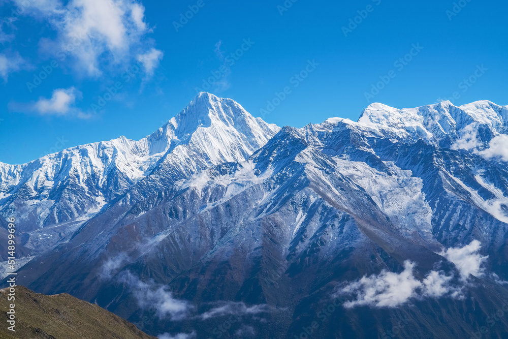 The natural beauty of Gongga snow mountain and blue sky and white clouds in Western Sichuan, China The natural beauty of Gongga snow mountain and blue sky and white clouds in Western Sichuan, China