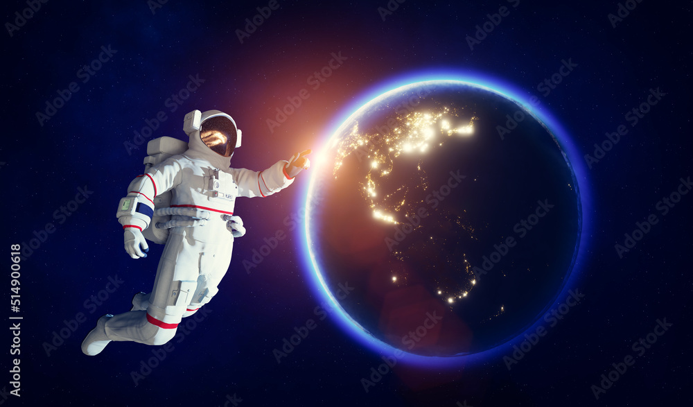 Obraz premium Astronaut spacewalk in space near Earth and pointing his finger