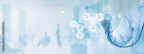 .Medicine doctor with stethoscope and icon health care on virtual interface and patients come to the hospital, Medical technology network, Healthcare and Medical concept. photo