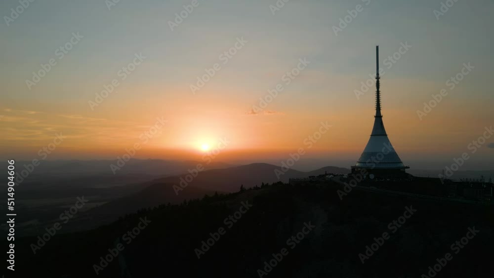 Silhouette of Jested Tower, Hotel, Restaurand and TV Tower in Liberec Czech Republic with sun setting in background Silhouette of Jested Tower, Hotel, Restaurand and TV Tower in Liberec Czech Republic with sun setting in background