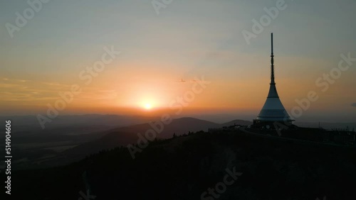 Silhouette of Jested Tower, Hotel, Restaurand and TV Tower in Liberec Czech Republic with sun setting in background photo