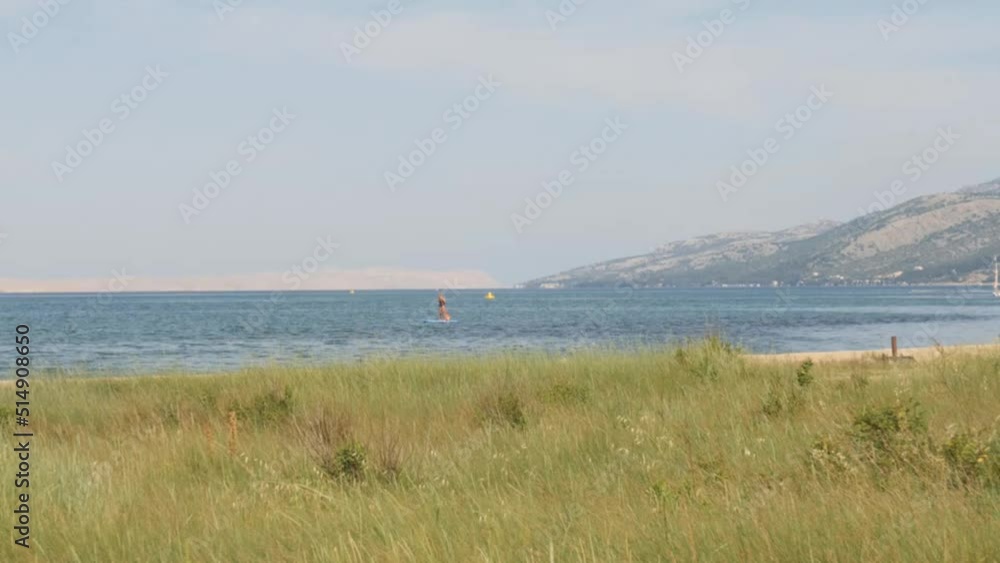 Croatian Coastline and Person Sup Boarding, Wide, Pan Croatian Coastline and Person Sup Boarding, Wide, Pan