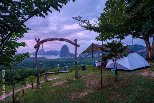 Camping tent at Sametnangshe, view of mountains in Phangnga bay with mangrove forest in Andaman sea with evening twilight sky, travel destination in Phangnga, Thailand photo