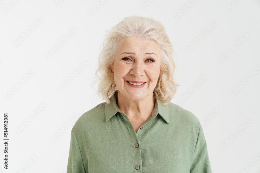 Grey senior woman in shirt smiling and looking at camera Grey senior woman in shirt smiling and looking at camera