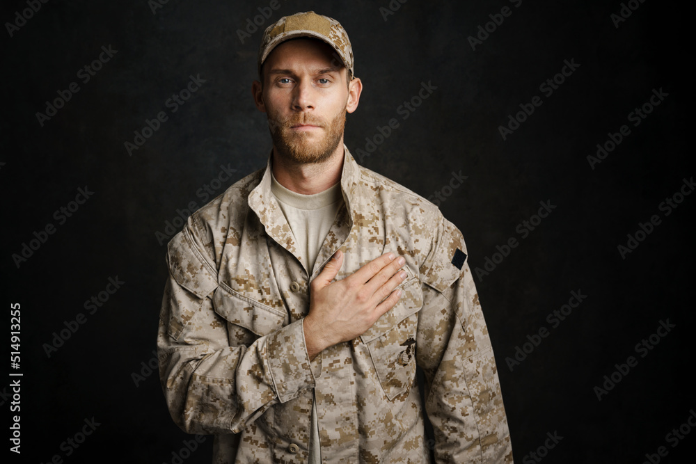 White military man wearing uniform holding hand on his chest White military man wearing uniform holding hand on his chest