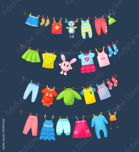 Baby clothes hanging on clothesline. Drying children's clothes and accessories after washing on rope. Shorts, socks, romper, sweater, hat, toys, T-shirt, sarafans, dress, skirts
