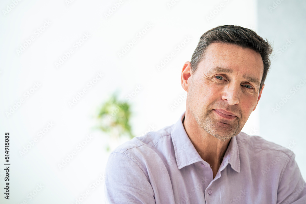 Mature businessman smiling at office