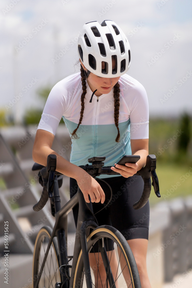 Cyclist using smart phone leaning on bicycle in park Cyclist using smart phone leaning on bicycle in park
