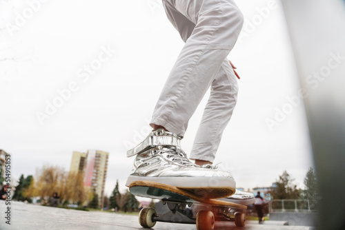 Legs of mature man on skateboard photo