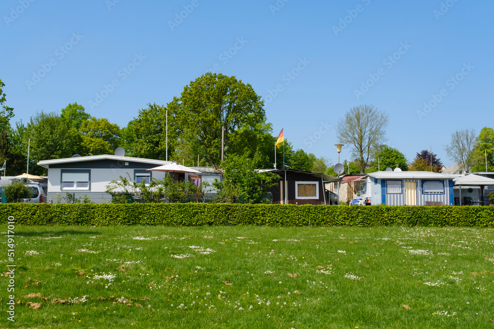 Germany, North Rhine-Westphalia, Mohnesee, Green lawn and hedge in front of summer campsite Germany, North Rhine-Westphalia, Mohnesee, Green lawn and hedge in front of summer campsite