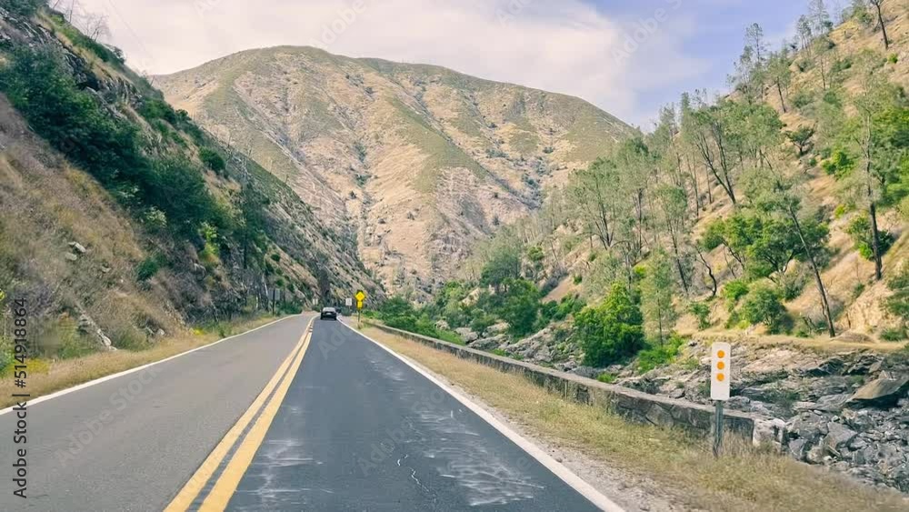 A view of a road in the mountains of California through the windshield of a car. A trip to Yosemite National Park by car. The amazing nature of California. A view of a road in the mountains of California through the windshield of a car. A trip to Yosemite National Park by car. The amazing nature of California.