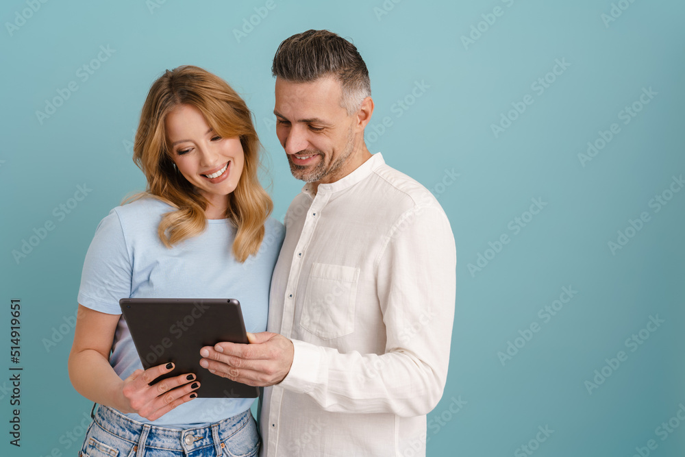 White happy couple hugging and using tablet computer White happy couple hugging and using tablet computer