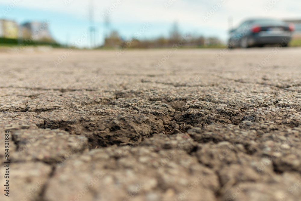 Empty damaged alphalt road in the street.Blurred blue sky,car background. Empty damaged alphalt road in the street.Blurred blue sky,car background.