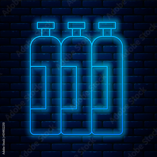 Glowing neon line Industrial gas cylinder tank for all inert and mixed inert gases icon isolated on brick wall background. Vector