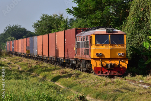 Thai container freight-train by diesel locomotive on the railway.