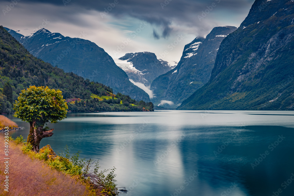 Gloomy summer view of Lovatnet lake, municipality of Stryn, Sogn og Fjordane county, Norway, Europe. Calm morning scene in Norway. Beauty of nature concept background. Gloomy summer view of Lovatnet lake, municipality of Stryn, Sogn og Fjordane county, Norway, Europe. Calm morning scene in Norway. Beauty of nature concept background.