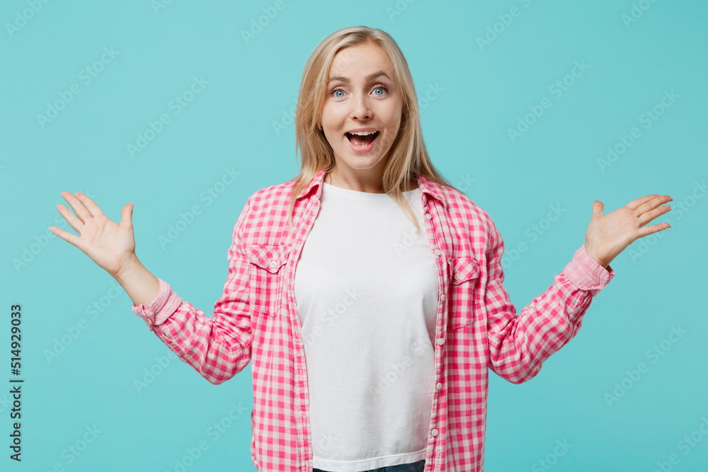 Young shocked excited fun amazed surprised woman she 30s wear pink shirt white t-shirt look camera spread hands isolated on plain pastel light blue background studio portrait People lifestyle concept Young shocked excited fun amazed surprised woman she 30s wear pink shirt white t-shirt look camera spread hands isolated on plain pastel light blue background studio portrait People lifestyle concept