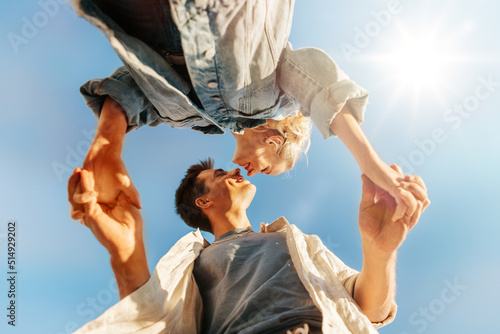 Tableau sur toile summer holidays, love and people concept - happy young couple holding hands unde