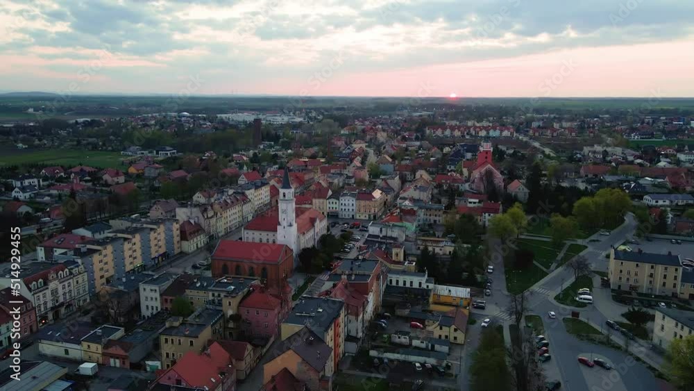 Overhead view of small town in Europe at sunset, Aerial view of Katy Wroclawskie in Poland, Flying drone over the center of small city with town hall, church and streets Overhead view of small town in Europe at sunset, Aerial view of Katy Wroclawskie in Poland, Flying drone over the center of small city with town hall, church and streets