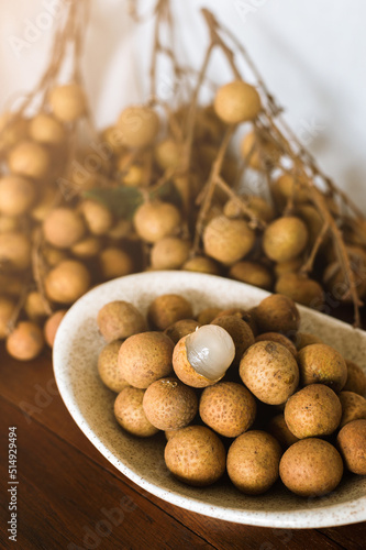 fresh longans in plate on wooden background