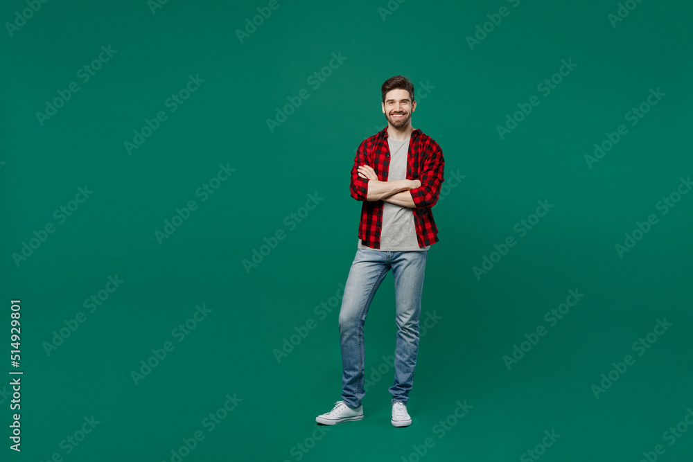 Full body young happy smiling caucasian man he 20s wear red shirt grey t-shirt hold hands crossed folded look camera isolated on plain dark green background studio portrait. People lifestyle concept. Full body young happy smiling caucasian man he 20s wear red shirt grey t-shirt hold hands crossed folded look camera isolated on plain dark green background studio portrait. People lifestyle concept.