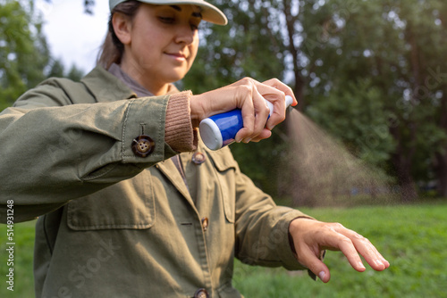 Vászonkép health care, protection and people concept - woman spraying insect repellent or