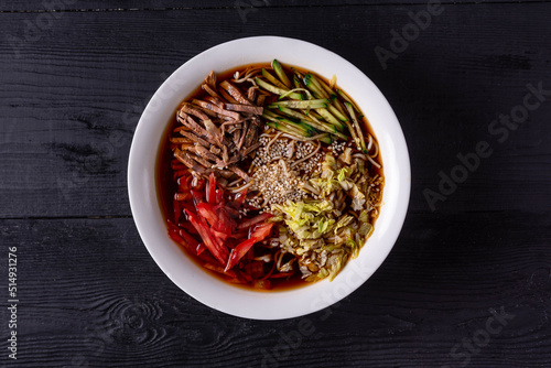 kuksi is a Korean national dish. on a black wooden background