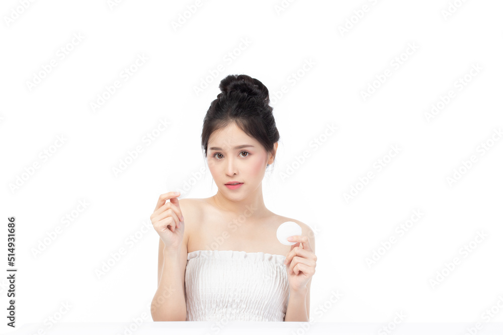 Attractive beauty young asian woman clean skin with cotton pad removing make up on isolated white background. Attractive beauty young asian woman clean skin with cotton pad removing make up on isolated white background.