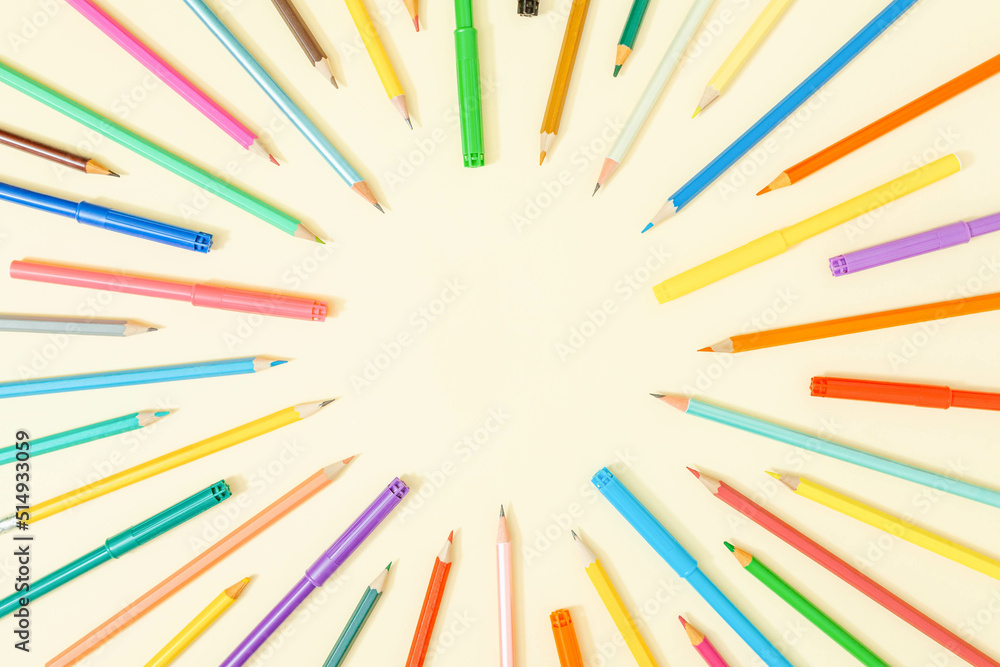 Cool composition with colorful pencils and crayons arranged in a circle on pastel sandy background. Creative copy space. Back to school template. Cool composition with colorful pencils and crayons arranged in a circle on pastel sandy background. Creative copy space. Back to school template.