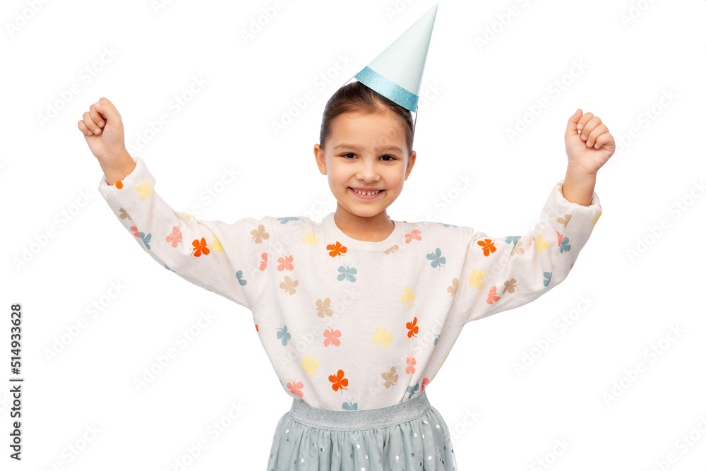 birthday, childhood and people concept - portrait of smiling little girl in dress and party hat making winning gesture over white background birthday, childhood and people concept - portrait of smiling little girl in dress and party hat making winning gesture over white background