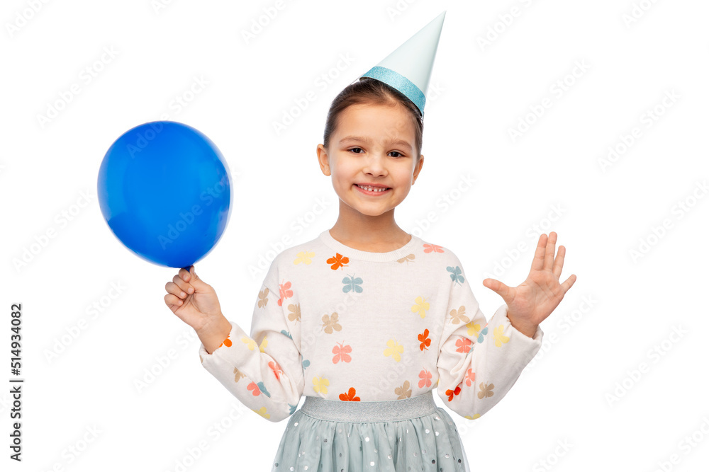 birthday, childhood and people concept - portrait of smiling little girl in dress and party hat blowing balloon over white background birthday, childhood and people concept - portrait of smiling little girl in dress and party hat blowing balloon over white background