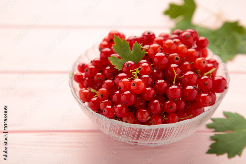 Bowl with ripe red currant on pink background. Bowl with ripe red currant on pink background.