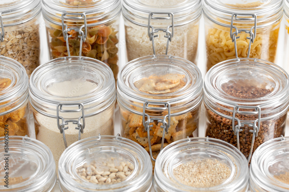 food storage, culinary and storage concept - jars with different cereals or groceries on table food storage, culinary and storage concept - jars with different cereals or groceries on table