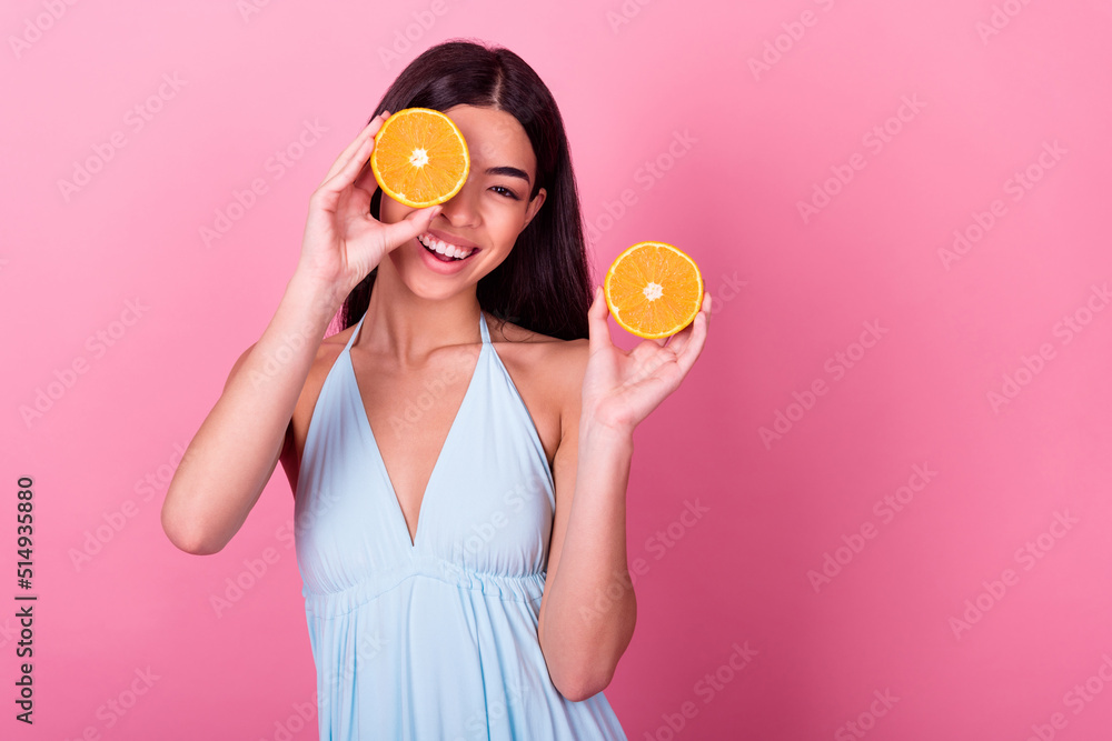 Photo of positive lovely sweet lady hold two mandarin slice hide face nourishing skin isolated pastel color background Photo of positive lovely sweet lady hold two mandarin slice hide face nourishing skin isolated pastel color background