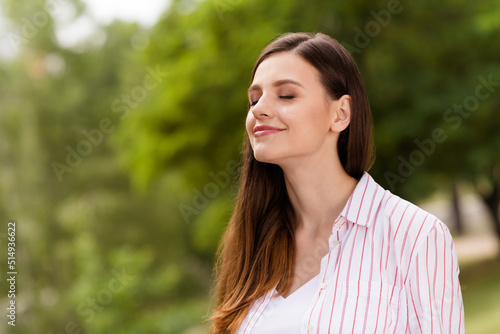 Photo of dreamy charming mother dressed casual clothes smiling closed eyes enjoying summer warm sun outdoors backyard