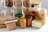 food storage and eating concept - close up of different cereals, groceries and preserves on table