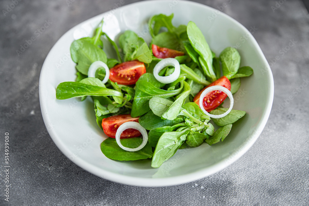 green salad vegetable tomato, onion, lettuce mix, mache green fresh healthy meal food snack diet on the table copy space food background rustic top view green salad vegetable tomato, onion, lettuce mix, mache green fresh healthy meal food snack diet on the table copy space food background rustic top view